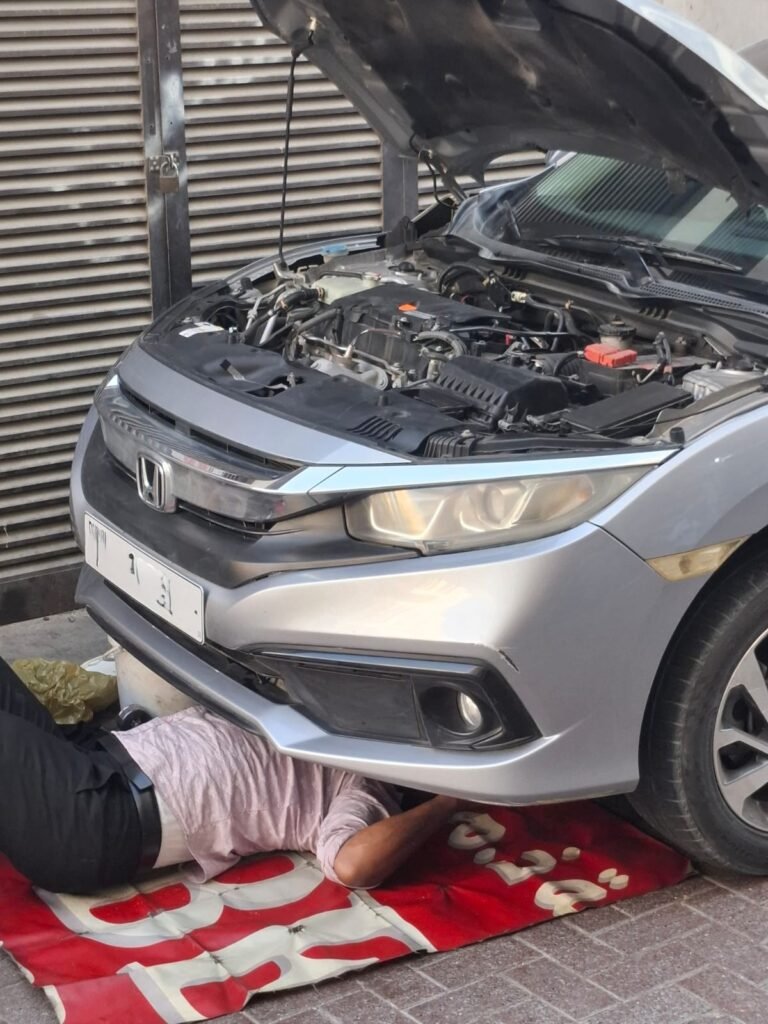 mobile mechanic changing car engine oil and oil filter