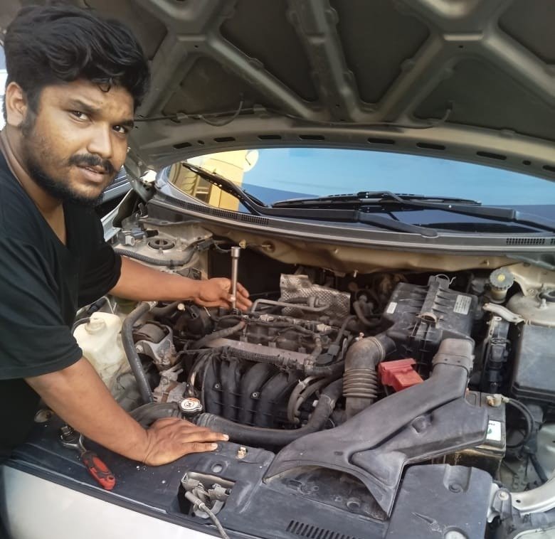 our mobile car mechanic repairing car in Dubai's parking area
